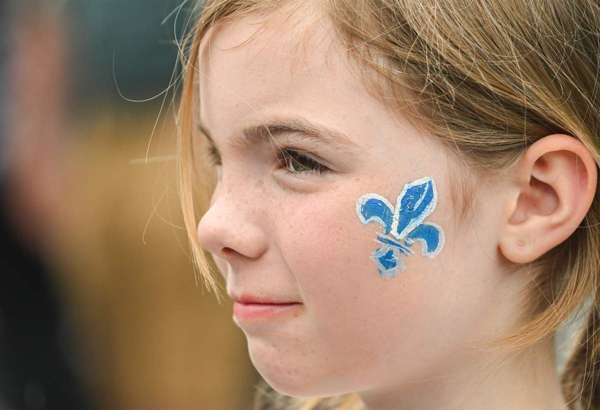 Eight year old Margot wears a fleur-de-lys on her face during Saint-Jean-Baptiste day in Montreal, Saturday, June 24, 2023.