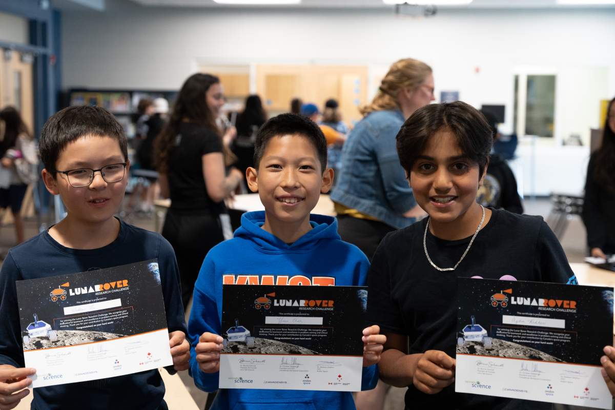 Left to right, Matthew Yu, Yisu Chen, and Aydin Rahbari submitted the successful bid that got their class the chance to operate a model lunar rover on June 8, 2023.