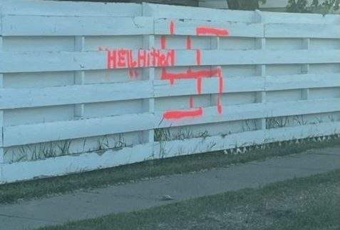 A swastika and the phrase "heil Hitler" are spraypainted on Jordan Barrett's fence in Calgary, on June 4, 2023. Police are investigating.