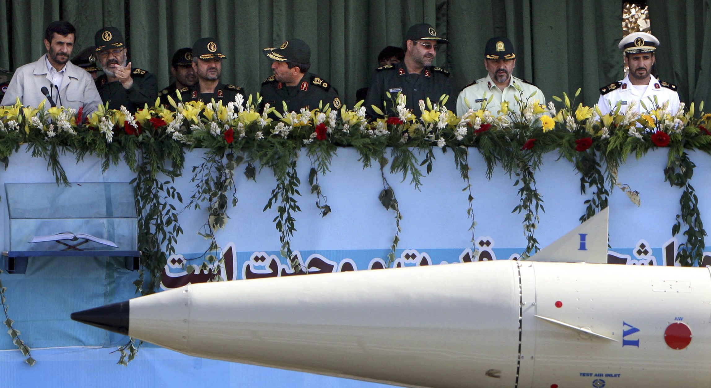 Iranian President Mahmoud Ahmadinejad, left, with Revolutionary Guards commanders as a Fateh 110 missile passes at military parade, Sept. 22, 2007. (AP Photo/Hasan Sarbakhshian)