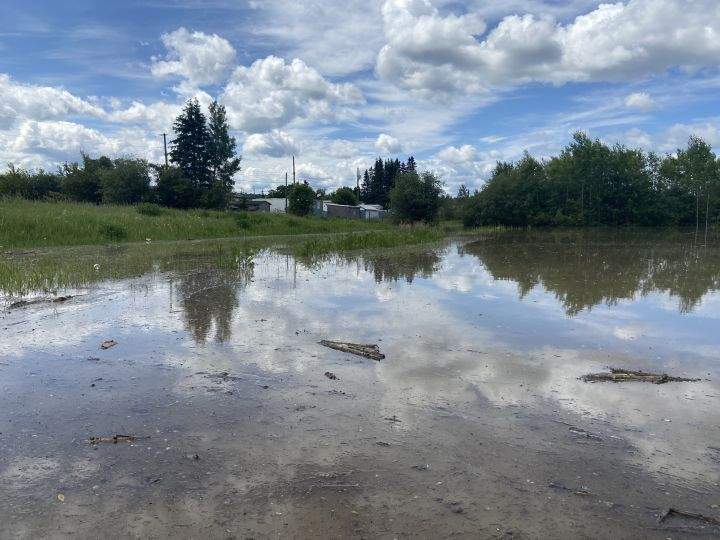Large pools of water left by heavy rain seen in Whitecourt, Alta., on June 20, 2023.