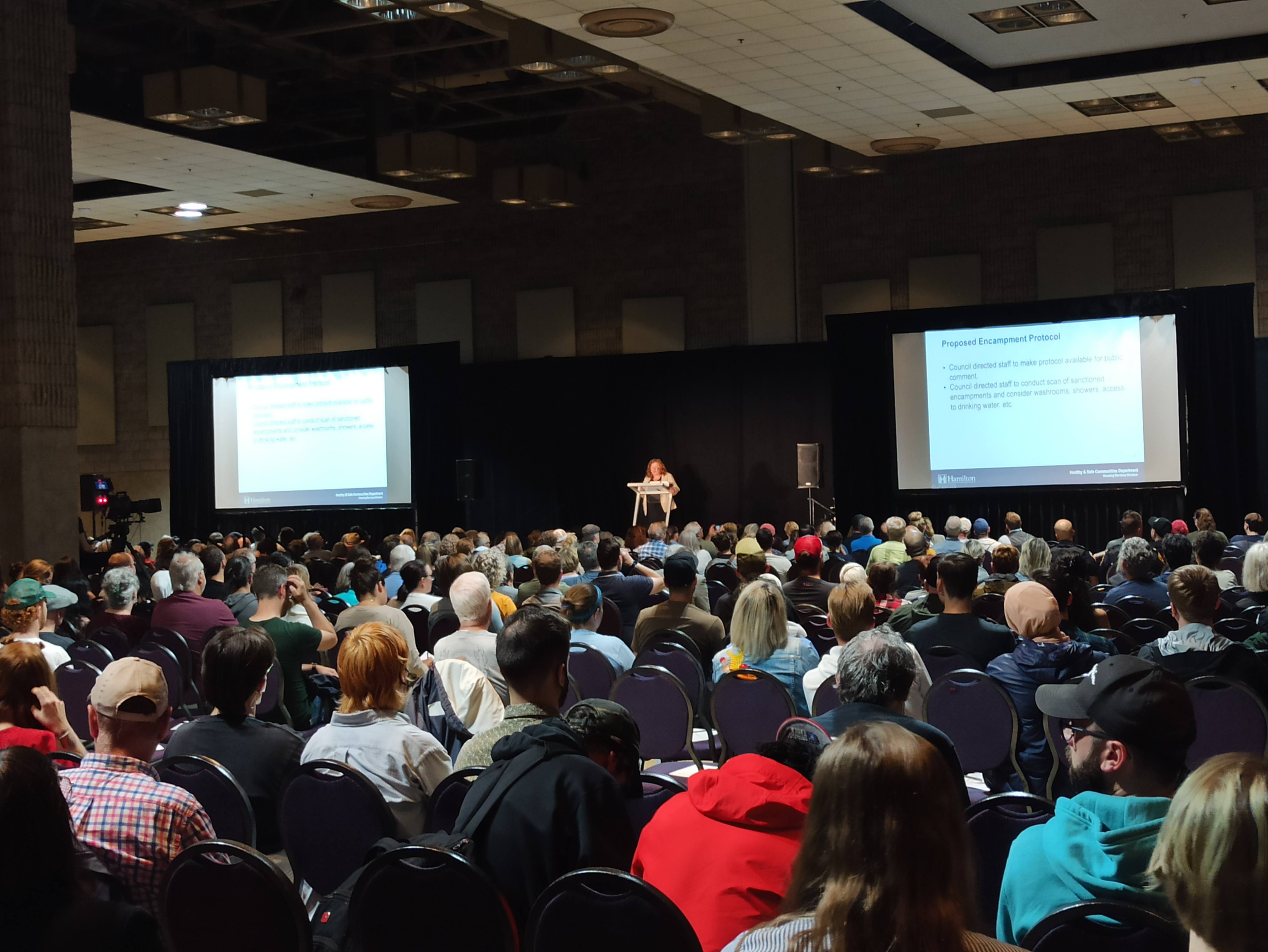 Close to 1,000 people turned out to a community meeting on June 27 in Hamilton to learn more about the city’s ongoing encampment issue.