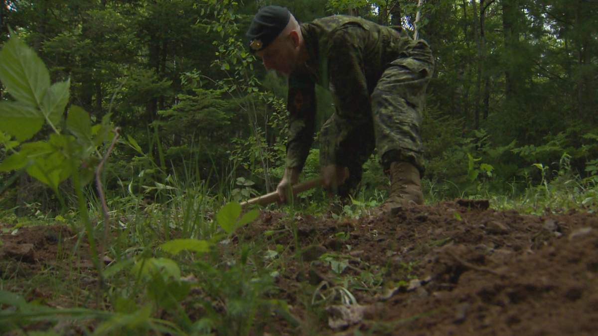 a man in camo digs dirt