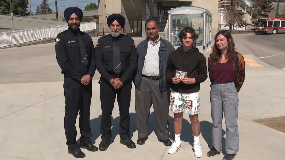 Sloan McGinn Thompson (second from right) stands holding the wallet he lost on a Calgary Transit bus. Transit supervisors Gurpal Guraya and Inderjit Chauhan, and driver Dominique Padmaraj (L to R) stand beside Sloan, with his mother on the opposite side, outside Anderson LRT Station on June 2, 2023.