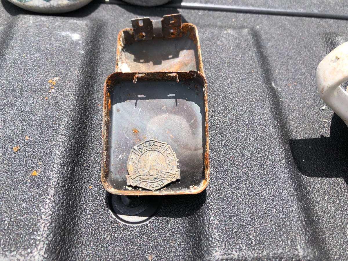 Mark Zawidzki's service pin for being a volunteer firefighter, which was saved from the rubble of the family home.