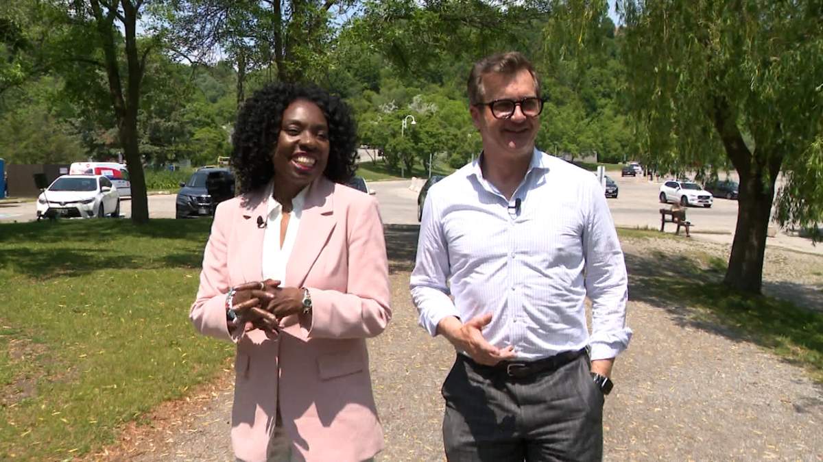 Toronto mayoral candidate Mitzie Hunter walks with Global News anchor Alan Carter.