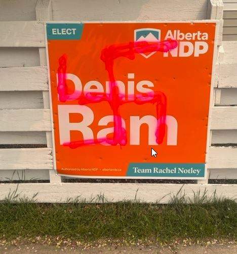 A swastika is painted over an election sign on Jordan Barrett's property in Calgary, in May, 2023.