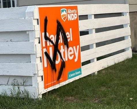 A swastika is painted over an election sign on Jordan Barrett's property in Calgary, in May, 2023.