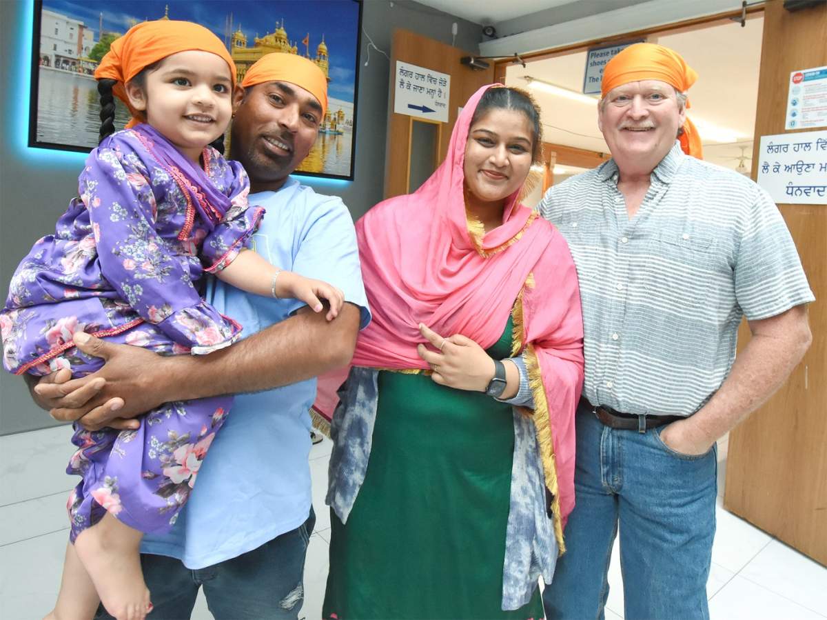 Hardeep Singh Chahal, left, seen here holding his daughter Keerat Kaur, Kamaldeep Kaur and friend Pierre Levesque pose for a photo at the Penticton Sikh Temple on Wednesday.