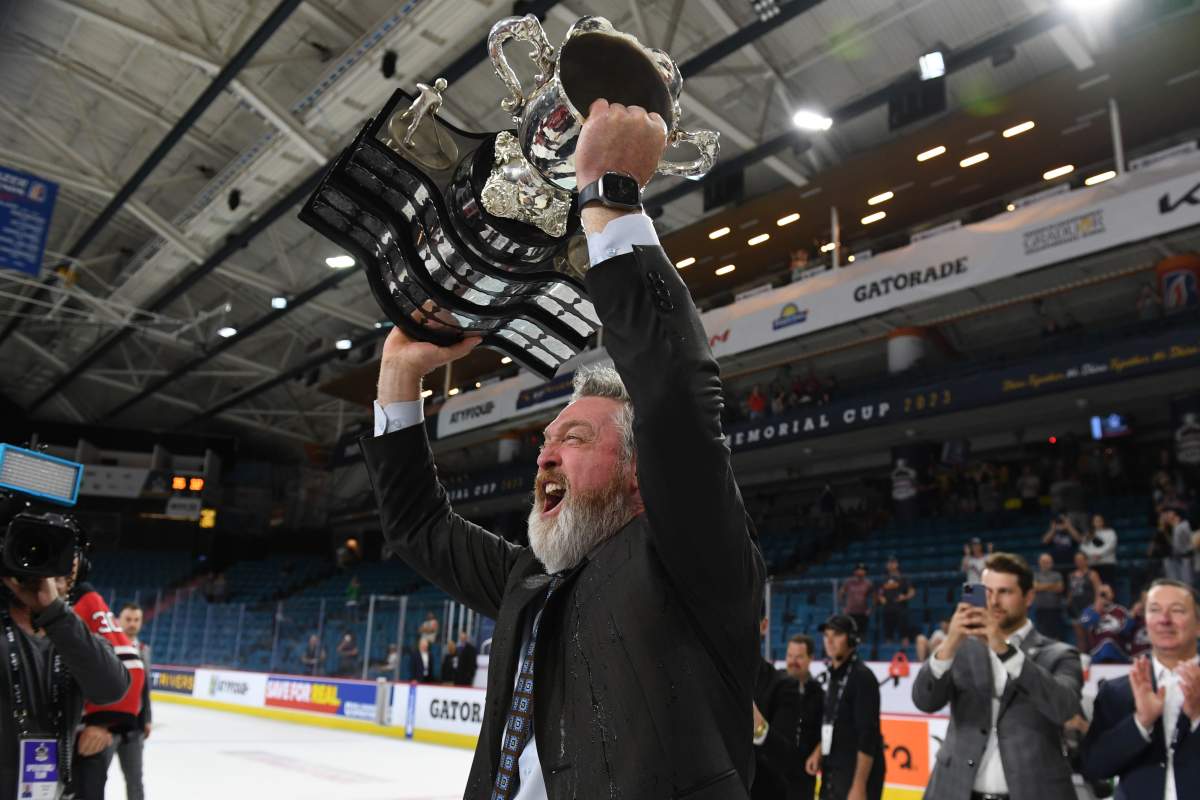 Quebec Remparts GM and head coach Patrick Roy hoists the Memorial Cup on Sunday in Kamloops, B.C.