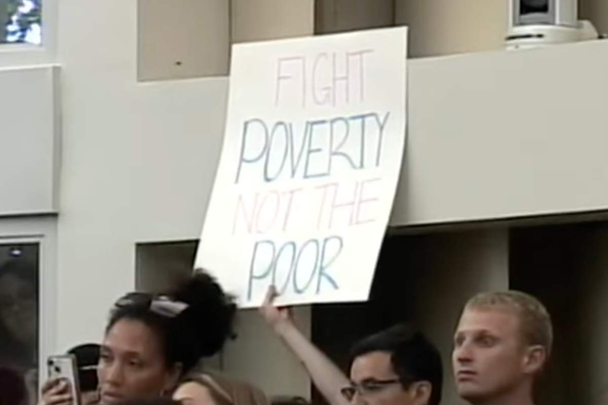 Residents holding signs protesting the bylaw’s changes in Barrie Ontario.