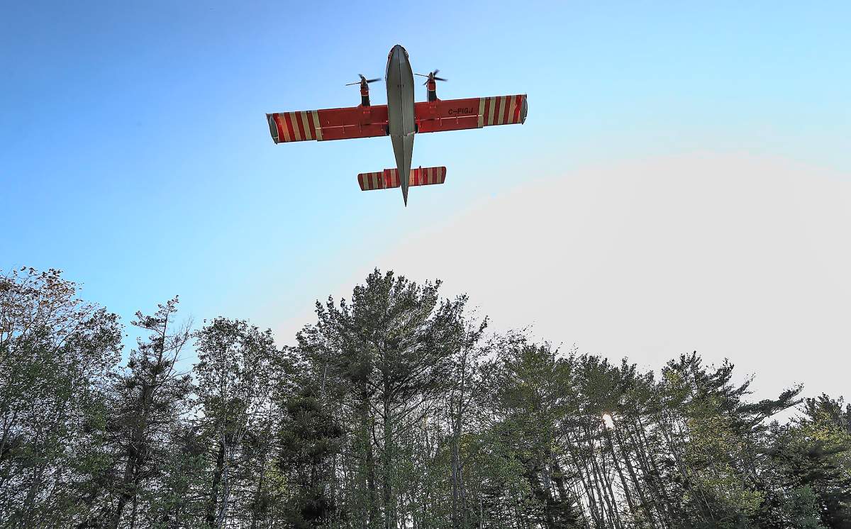 A water bomber heads for a drop at the fire site near Sandy Point, Shelburne County, on Wednesday, May 31, 2023.