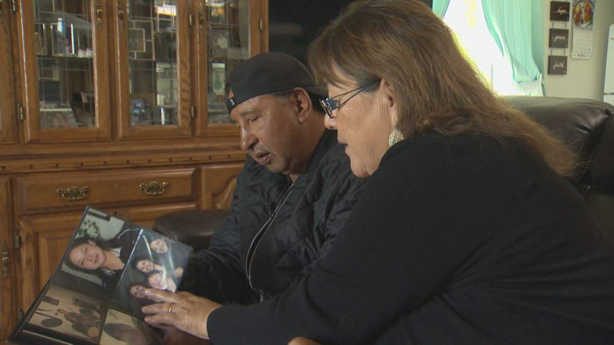 Wilfred & Bernice Catcheway look through old photos of their daughter Jennifer in their home on Skownan First Nation, Man.