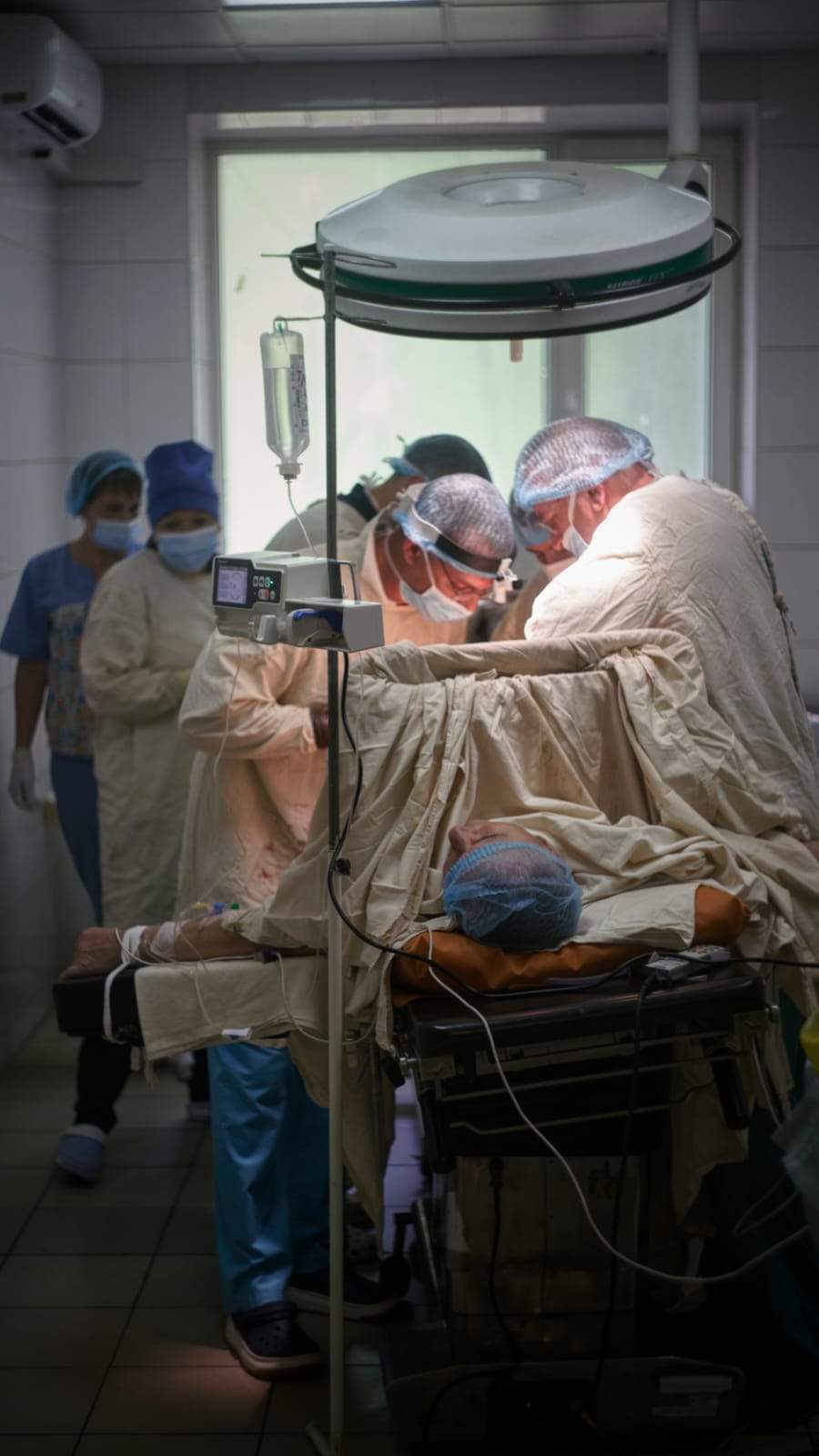 Ukrainian trauma surgeons operate on a solider.