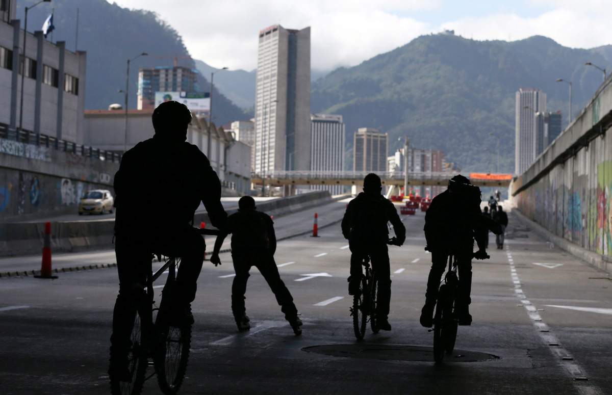 Commuters on bikes ride downtown Bogota, Colombia.