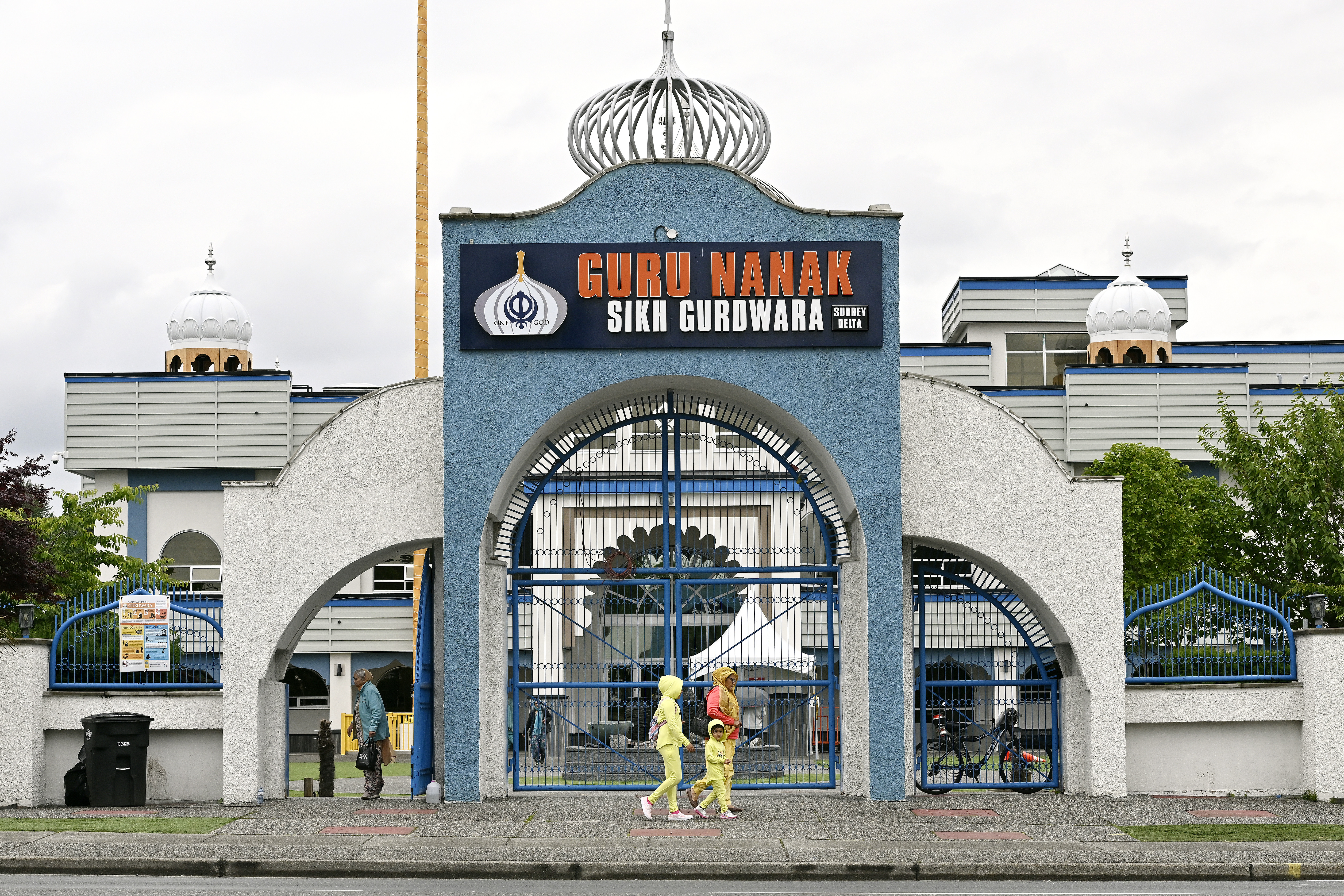 Community members exit the Guru Nanak Sikh Gurdwara Sahib temple, in Surrey, B.C., on Monday. THE CANADIAN PRESS/Jennifer Gauthier