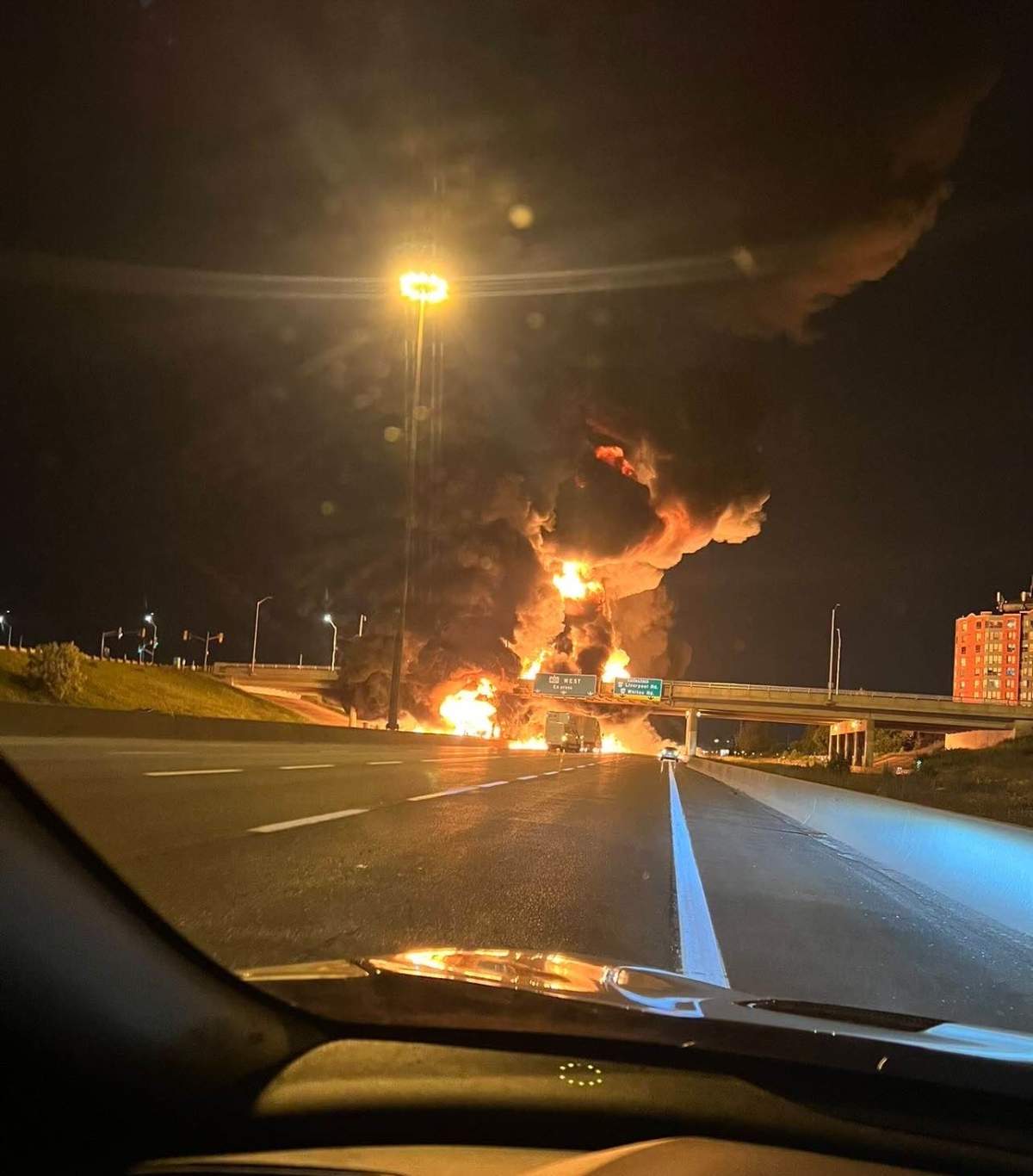 A driver takes a photo of the fiery explosion following a crash on Highway 401 in Pickering on Tuesday.
