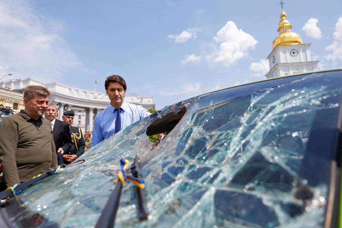 Trudeau looks at an exhibition of vehicles destroyed by war in Ukraine,