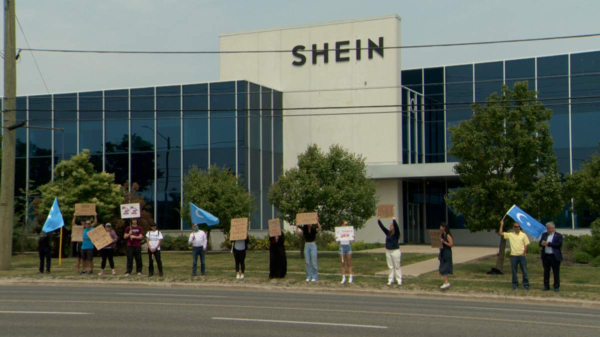 A small group of protesters gather outside a recently-opened distribution facility for Chinese fashion giant Shein on June 10, 2023.