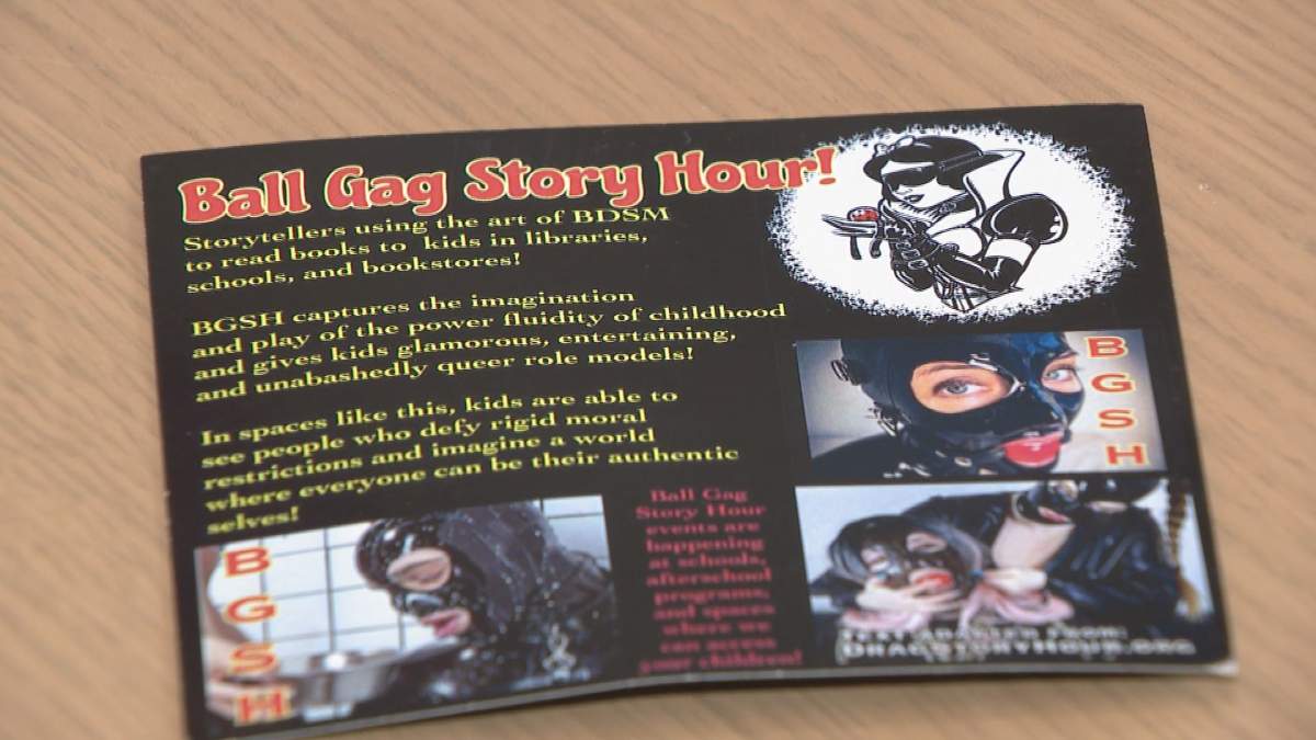 One of several cards scattered in front of OutSaskatoon and the sexual health office’s building Thursday morning claiming drag story time is the same as BDSM activities.