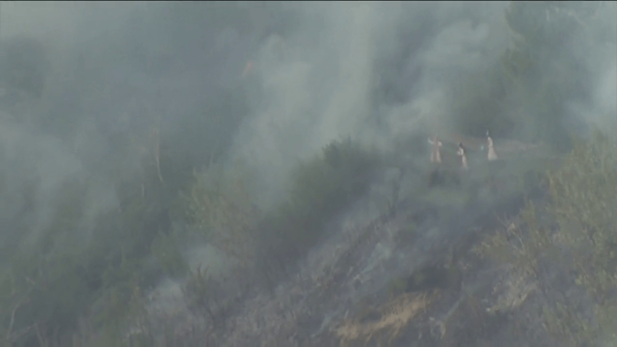 Nuns trying to put out a grass fire at the Sisters of the Precious Blood monastery located near the southwest neighbourhoods of Roxboro and Mission.