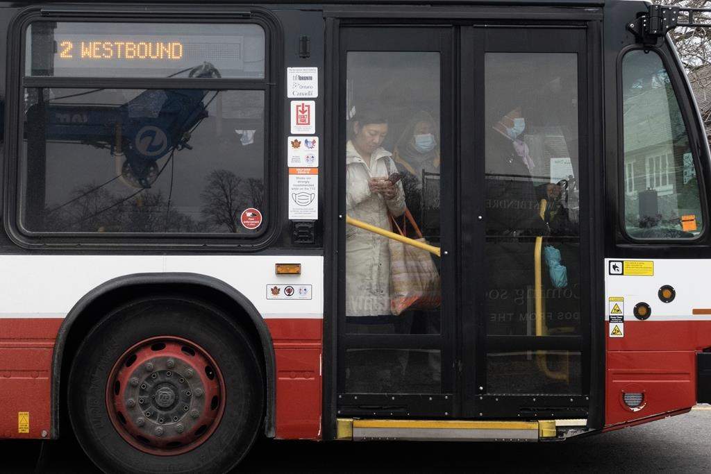 People ride on a shuttle bus outside a west-end Toronto subway stop after subway service was closed during the morning commute Wednesday, April 5, 2023. Toronto had the least reliable transit system in 2022 compared to other municipalities in the region, according to newly released transit report cards from the Toronto Region Board of Trade. THE CANADIAN PRESS/Graeme Roy.
