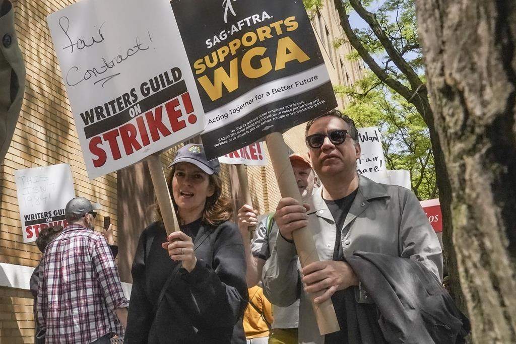 FILE – Actors and comedians Tina Fey, center, and Fred Armisen, right, join striking members of the Writers Guild of America on the picket line during a rally outside Silvercup Studios, Tuesday May 9, 2023, in New York. Unionized Hollywood actors on the verge of a strike have agreed to allow a last-minute intervention from federal mediators but say they doubt a deal will be reached by a negotiation deadline late Wednesday, July 12, 2023. (AP Photo/Bebeto Matthews, File)