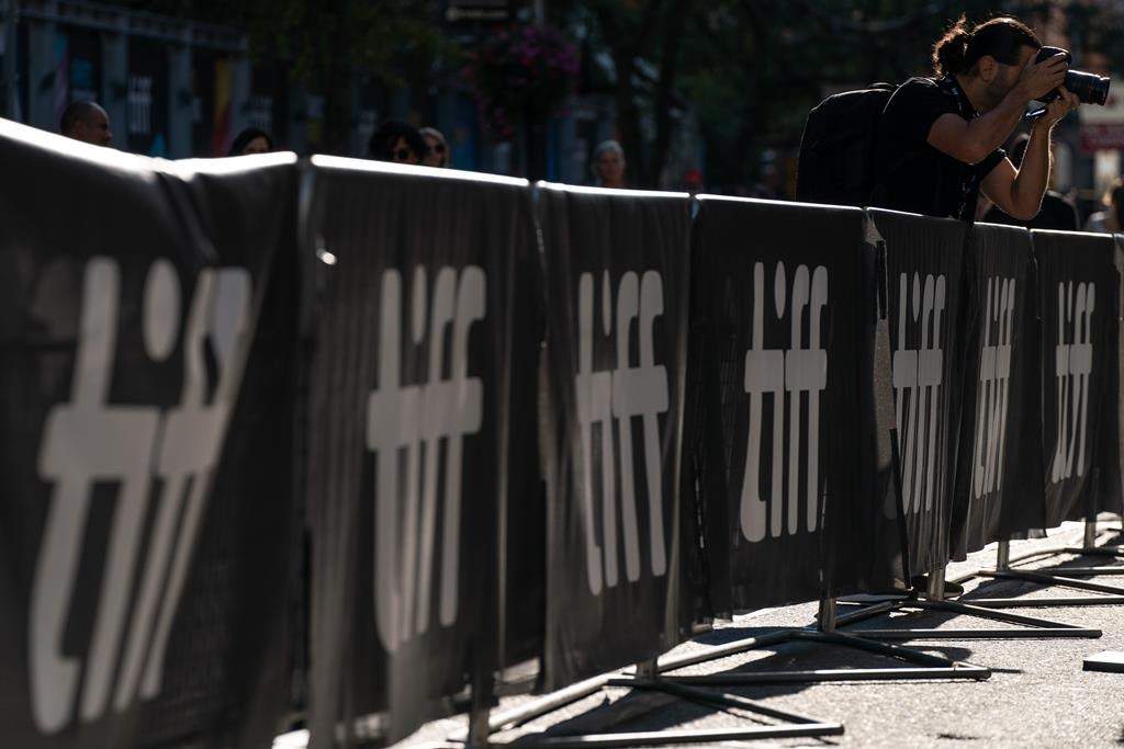 A photographer takes a photo at TIFF's kick off event in Toronto, Thursday, Sept. 8, 2022. 