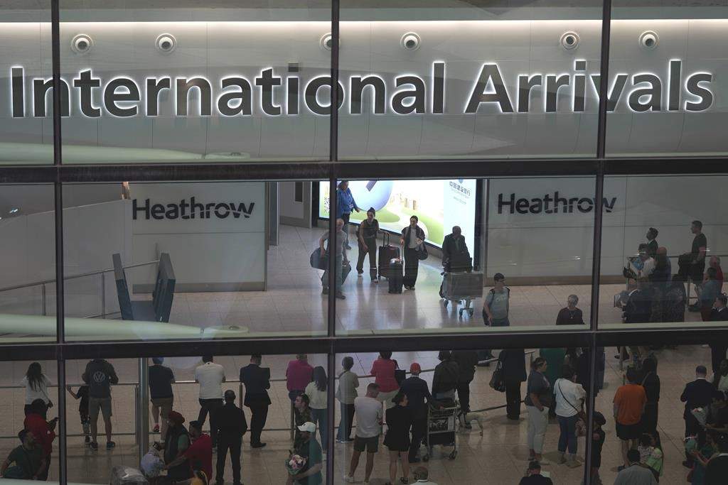 Passengers arrive at the Heathrow Airport, in London Saturday, May 27, 2023.