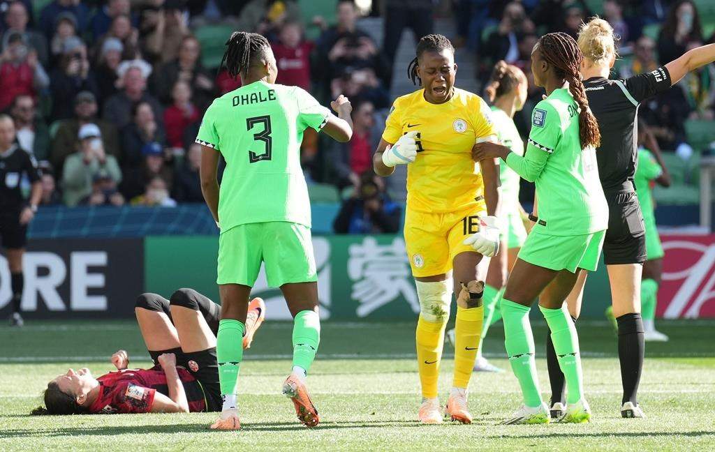 Canada’s Christine Sinclair reacts on the ground after missing a penalty kick as Nigeria goalkeeper Chiamaka Nnadozie, centre, celebrates with teammates during second half Group B soccer action at the FIFA Women’s World Cup in Melbourne, Australia, Friday, July 21, 2023.