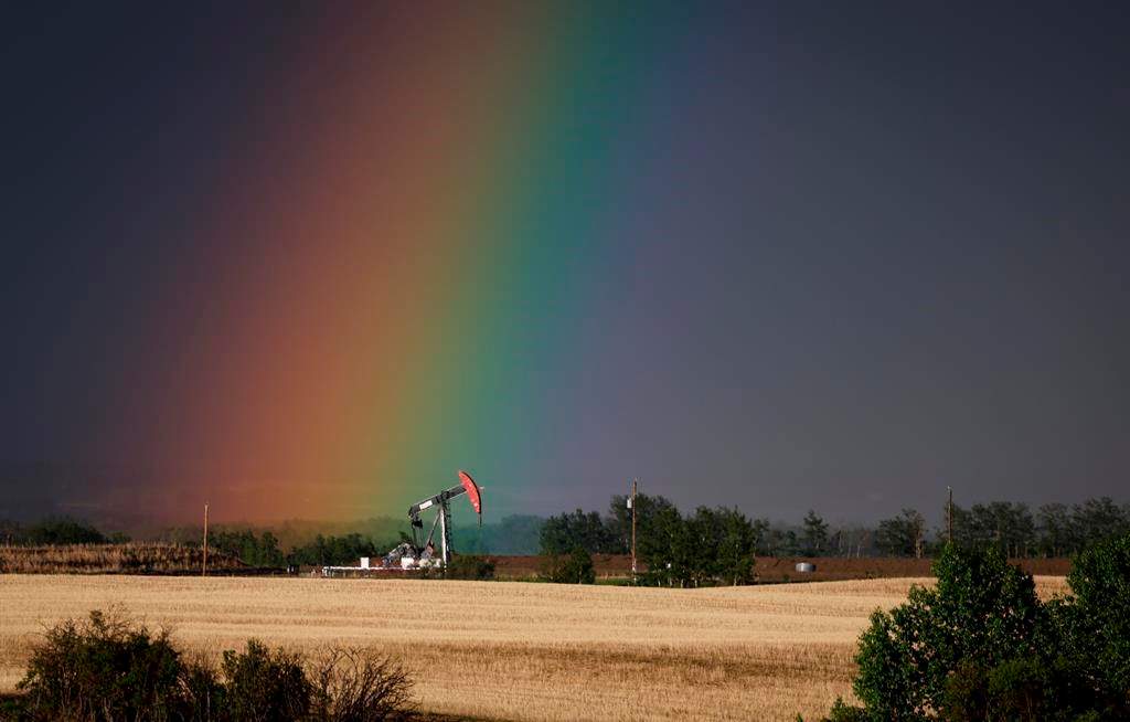 Analysts say they're expecting strong second quarter earnings from Canadian heavy oil producers. A pumpjack draws out oil and gas from a well head as a rainbow shines down on it near Calgary, Alta., Sunday, May 28, 2023.