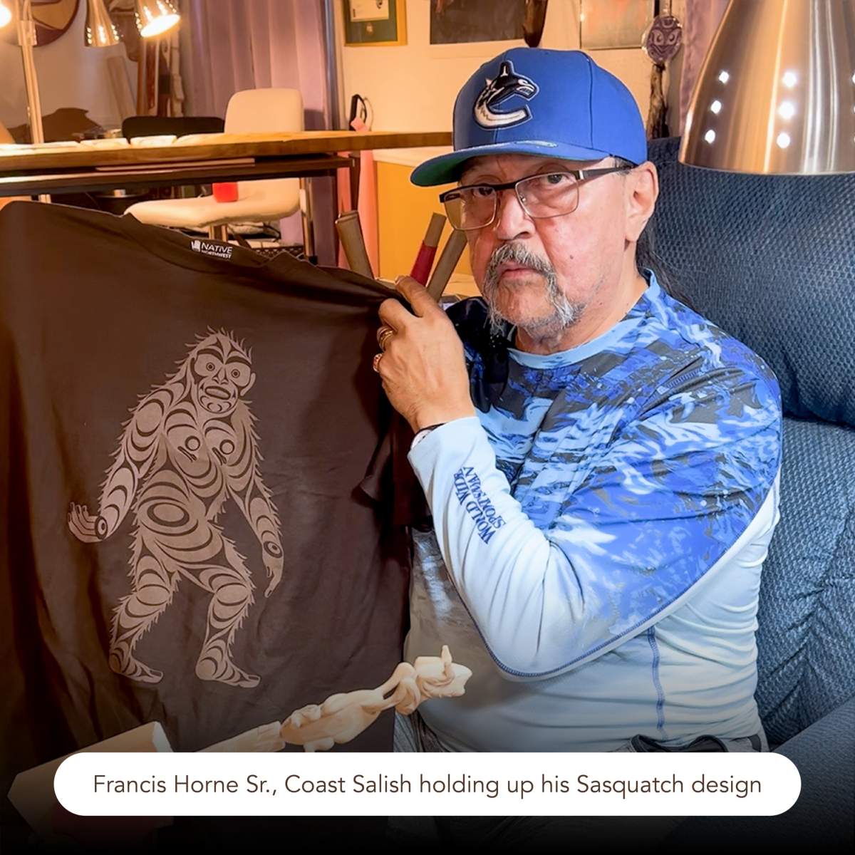 A man holds up his design
