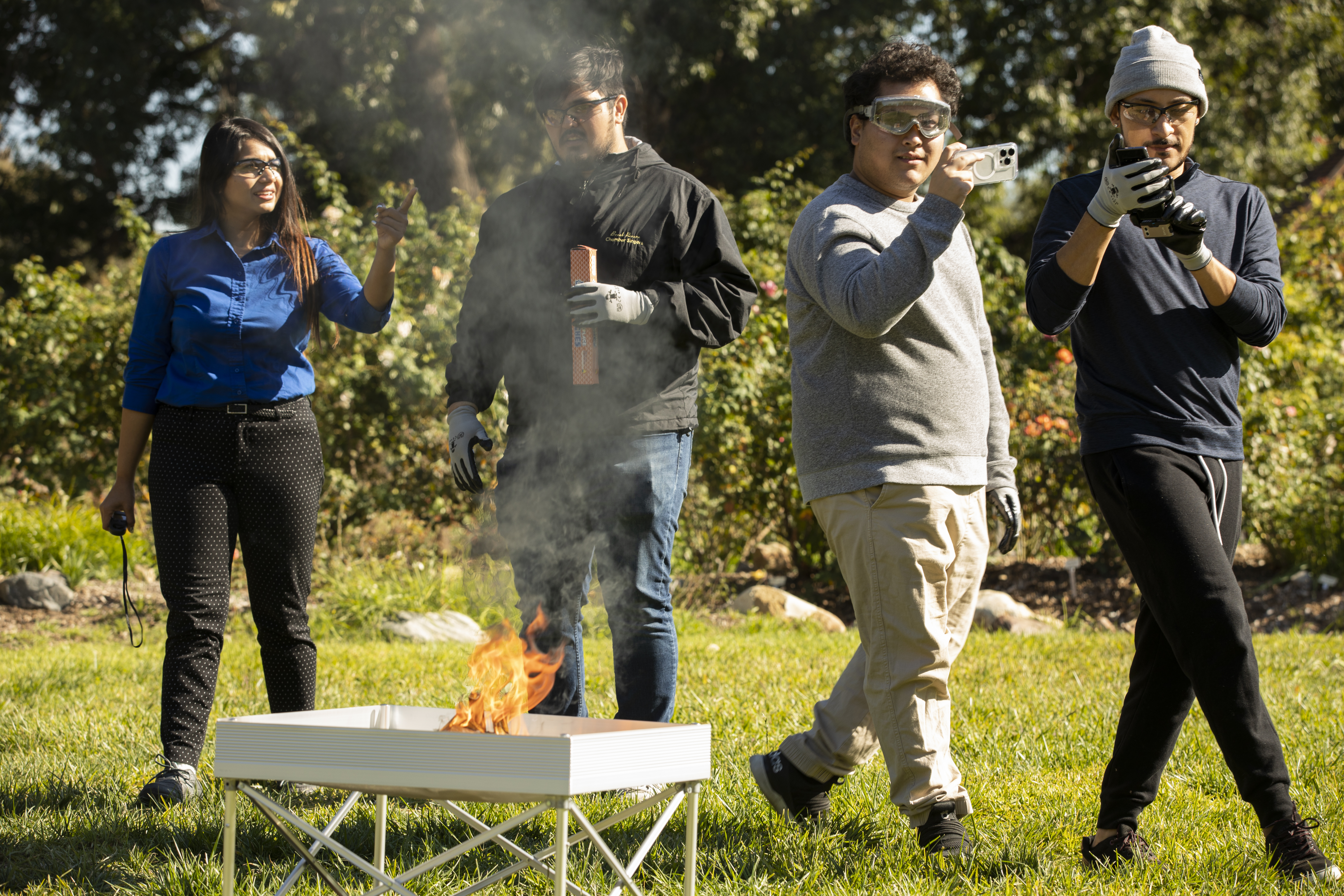 Students and their professor, Ankita Mohapatra, ignite small fires at California State University, Fullerton, to test remote fire sensing technology. The sensors, installed close to or in the forest, can detect fires in the very early stages – before they turn into raging infernos.