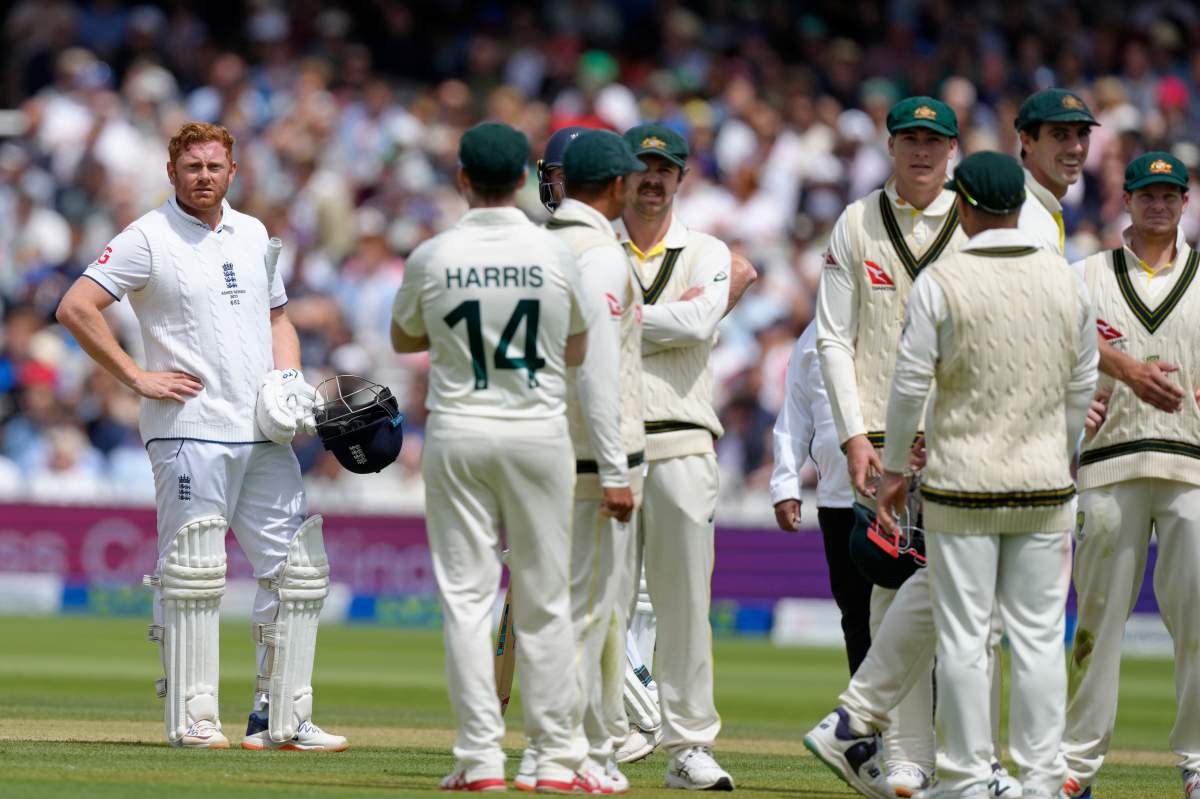 England's Jonny Bairstow, left, reacts as he watches the replay of his dismissal on a big screen during the fifth day of the second Ashes Test match between England and Australia