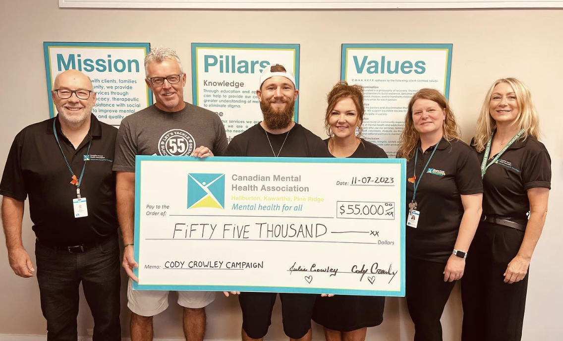 Douro pro boxer Cody Crowley, third from left, presents a cheque for $55,000 to the Canadian Mental Health Association on July 11, 2023.