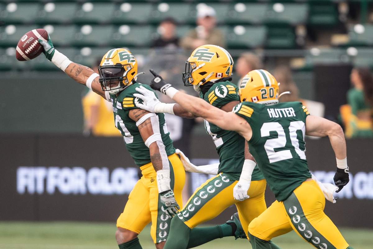 Elks linebacker Jordan Reaves is surrounded by teammates after recovering a Tiger-Cats fumble.
