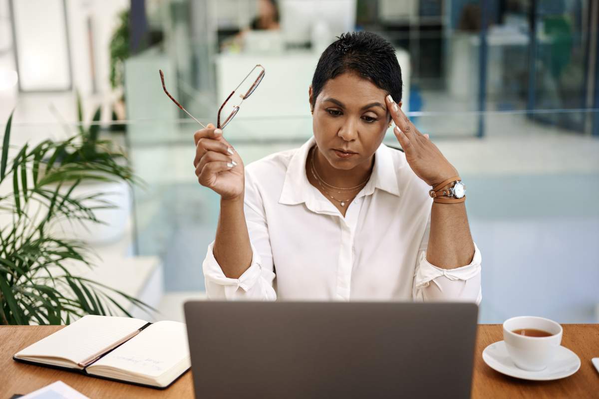 Shot of a mature businesswoman looking stressed out while working on a laptop in an office