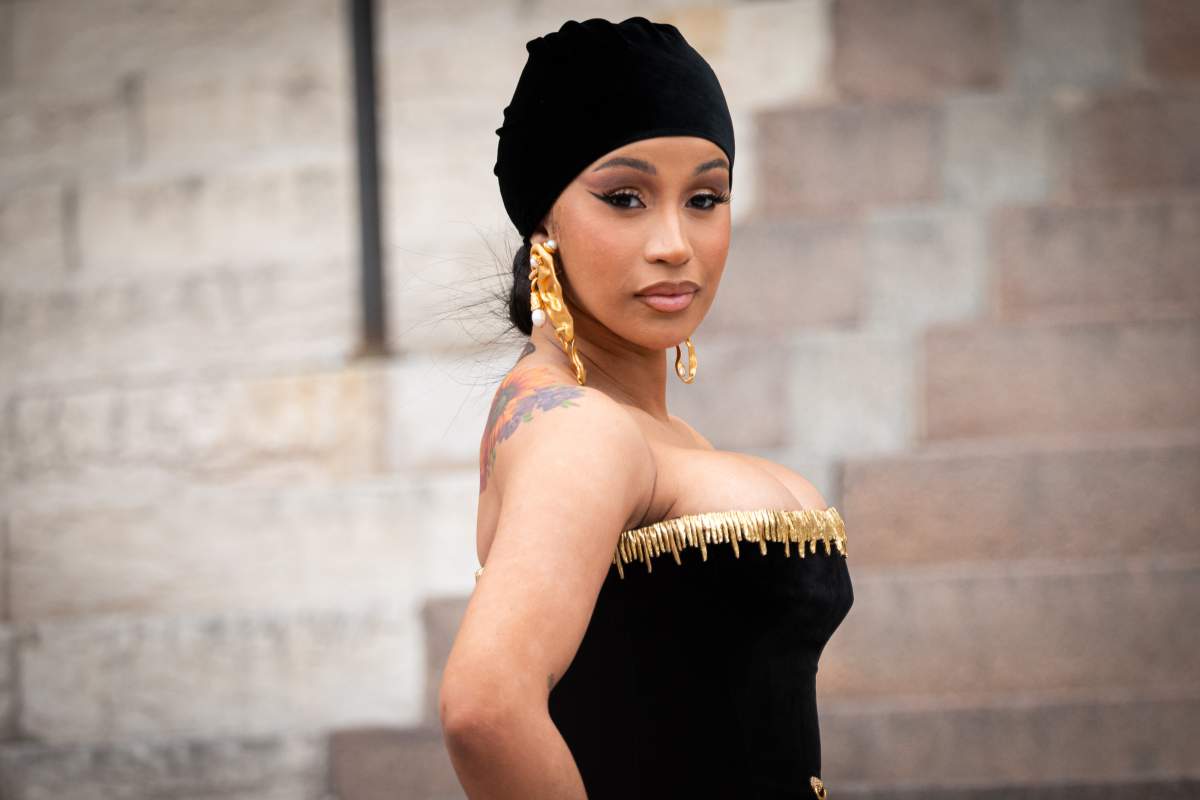 Cardi B in a black dress and head scarf.