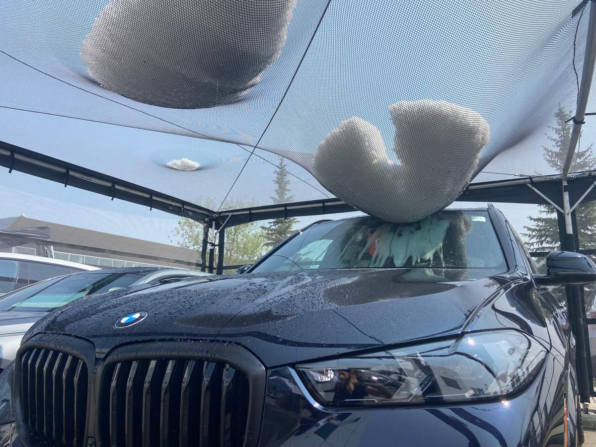 Hail collected during a Calgary storm saves cars from being damaged at a BMW dealership Sunday, July 16, 2023.