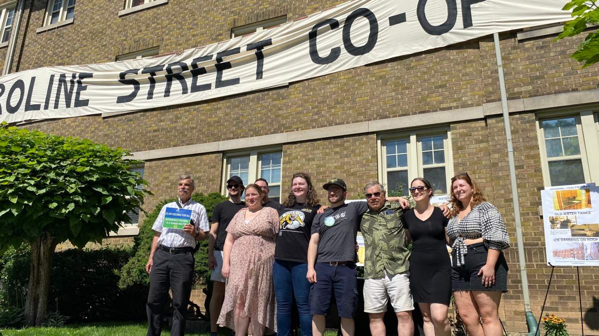 Residents at 272 Caroline Street south at a media conference out front of their building on Caroline at Herkimer Street in Hamilton, Ont. July 13, 2023. The group, who banded together to buy the 21 unit building, are seeking a reduction in the asking price alleging expensive fixes will soon be needed.
