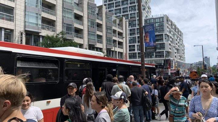 People head onto shuttle buses at Eglinton Station after a stabbing onboard a subway train led to a closure on Line 1 Thursday.