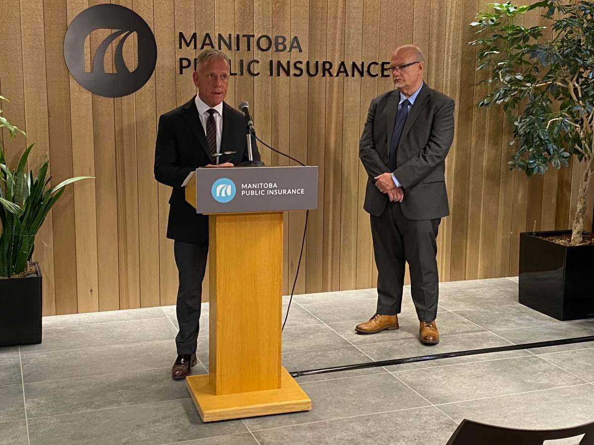 MPI’s Ward Keith speaks to media as justice minister Kelvin Goertzen looks on.