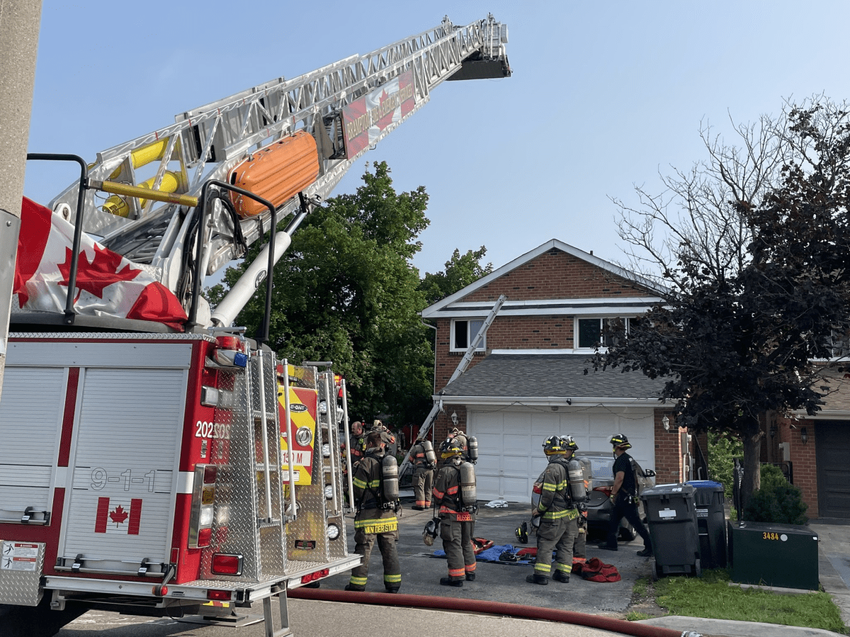 Firefighters outside a house fire in Brampton on July 26, 2023.