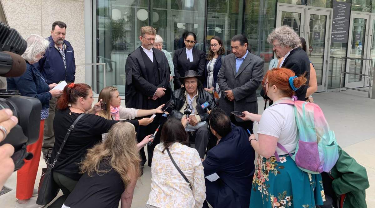 Allan Woodhouse (middle) and Brian Anderson (top right) speak outside the Winnipeg Law Courts after being acquitted of the murder of Ting Fong Chan in 1973.