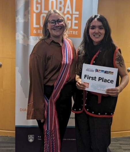 A pair stand holding a sign that reads first place.