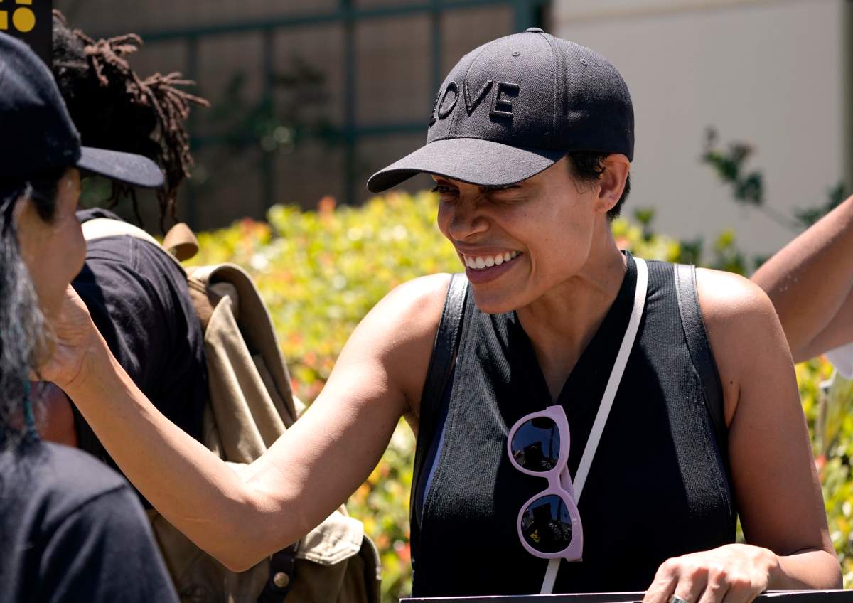Actor Rosario Dawson pickets.