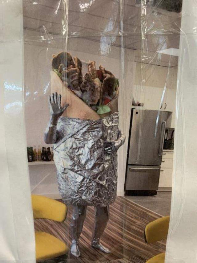 Someone wearing the donair costume waves hello to the mirror.