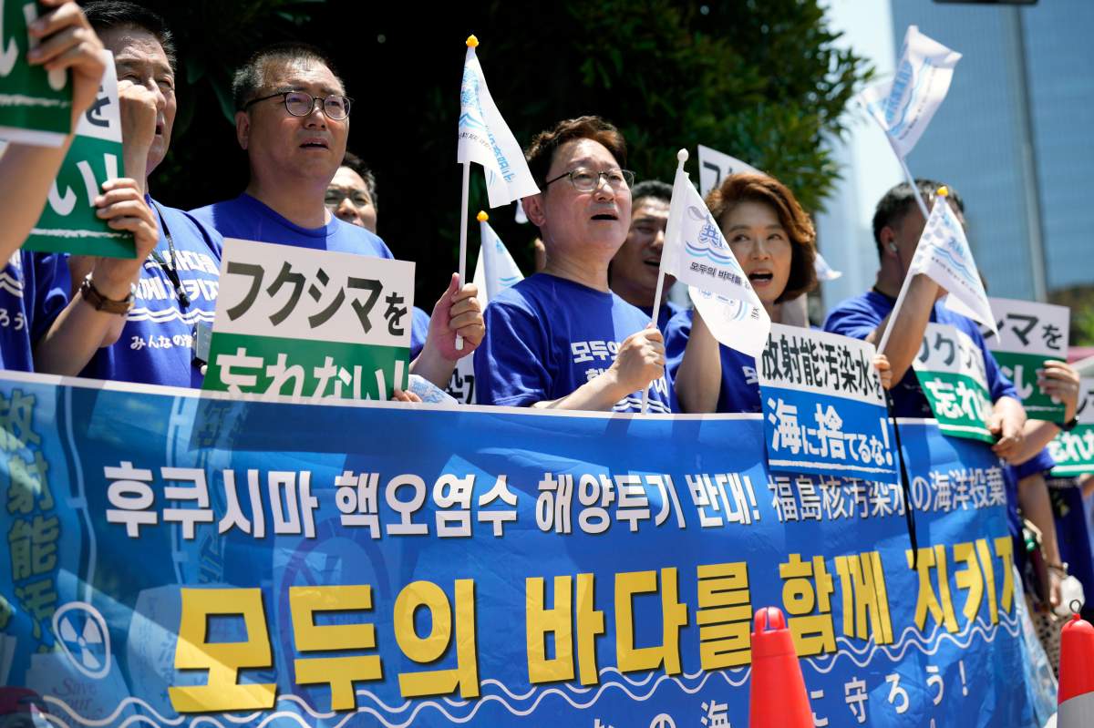 South Korean lawmakers hold placards and a banner against Japanese plans to release treated radioactive water from the damaged Fukushima nuclear power plant, during a rally in front of the Prime Minister’s office Monday, July 10, 2023, in Tokyo. (AP Photo/Eugene Hoshiko)