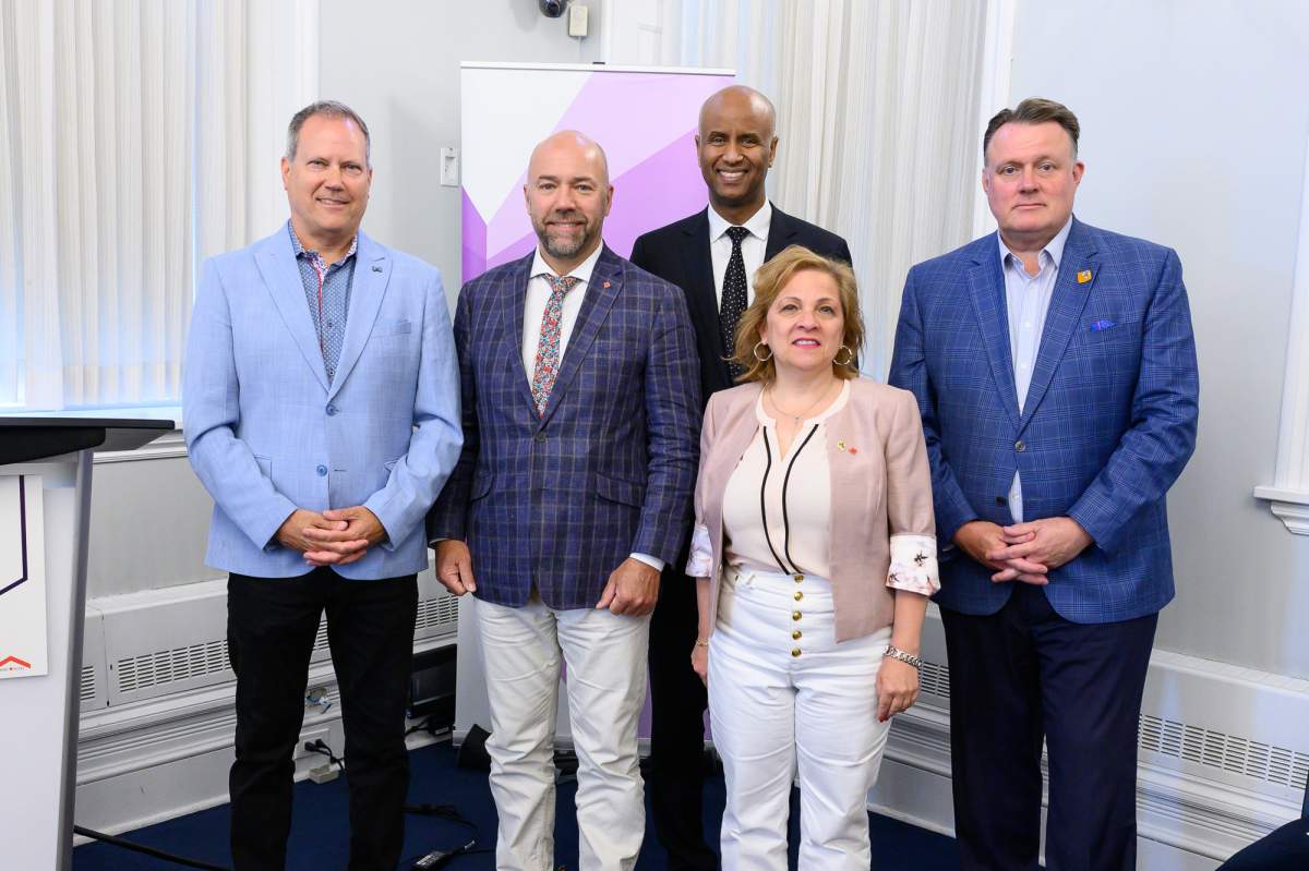 MPs Darren Fisher, Andy Fillmore and Lena Metledge Diab, along with federal Housing Minister Ahmed Hussen and Halifax Mayor Mike Savage, are pictured during the announcement Monday.