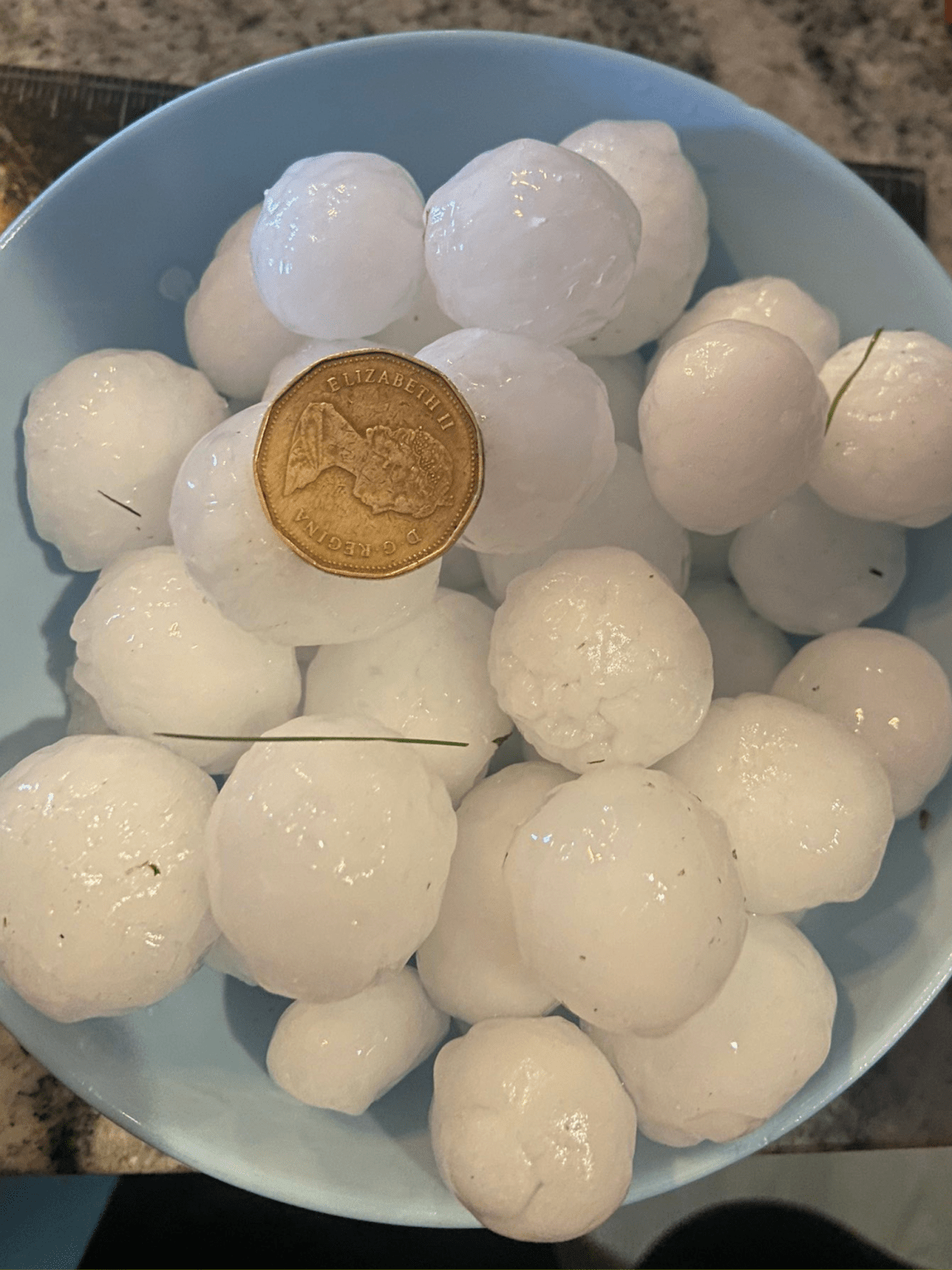 A photo of the ping pong ball sized hail seen in Calgary on July 17, 2023.
